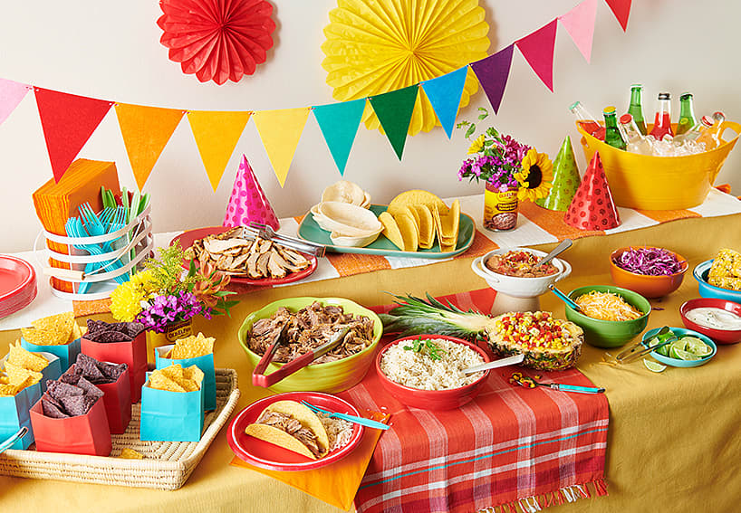 picture of a colorful fiesta with tacos and nachos