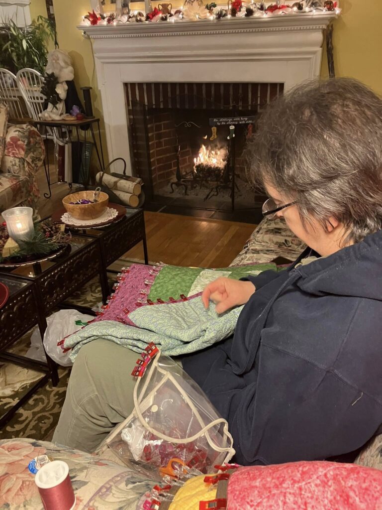 member works on a knitting project