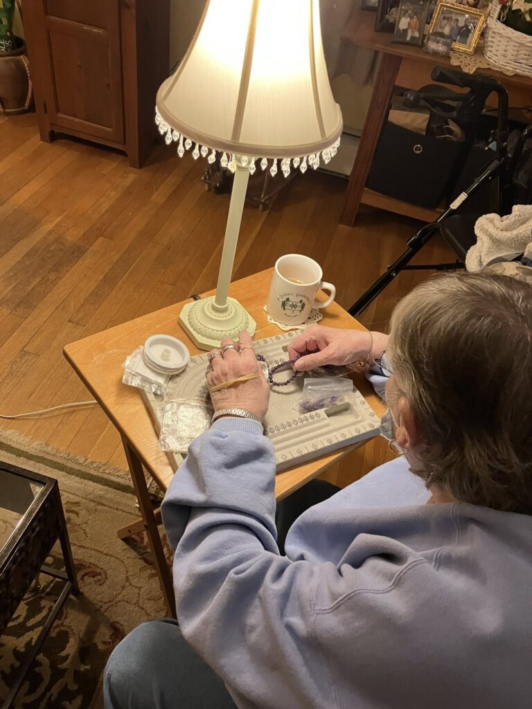 member works on a beading project