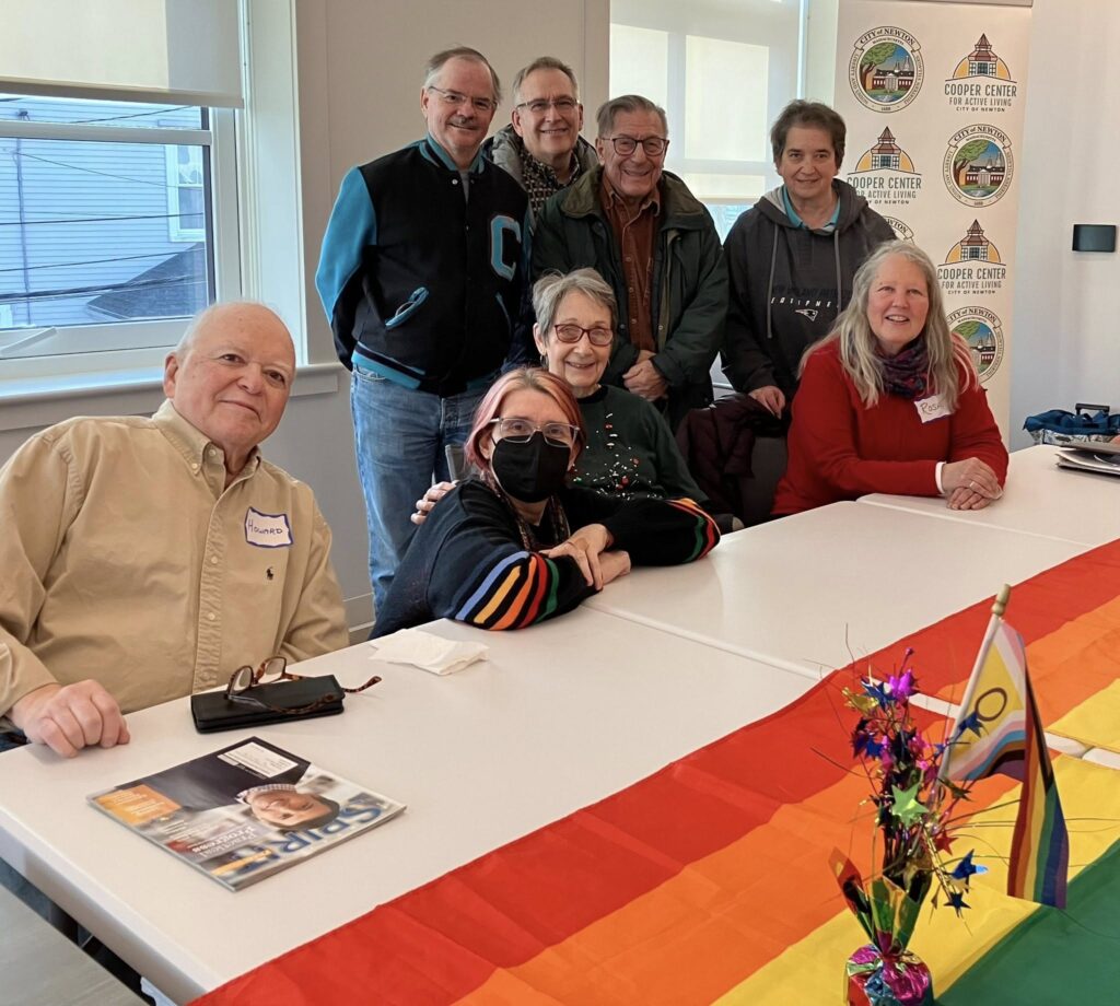 group gathers at a table for a photo