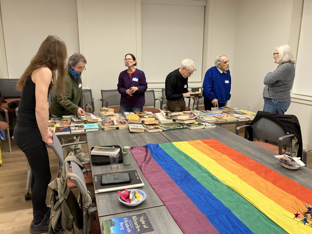 LGBTQ+ Newton members browsing books at the book swap