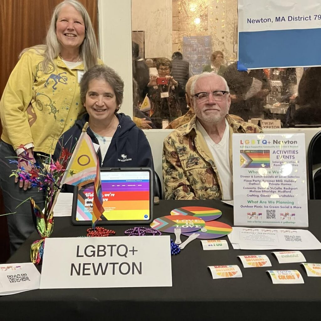 photo of members of LGBTQ+ Newton sitting at a table at West Newton Cinema